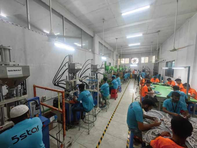 Technicians in 5Star Digi-Tech uniforms operating injection-molding machines
