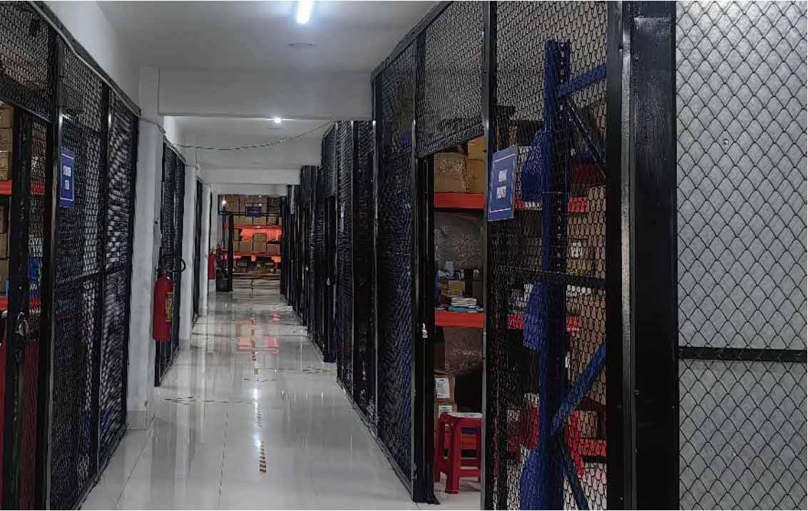 Racked warehouse storage aisles with caged inventory bays